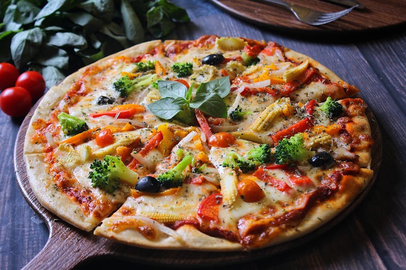 Close-up of dions pizza slice with melted cheese and toppings